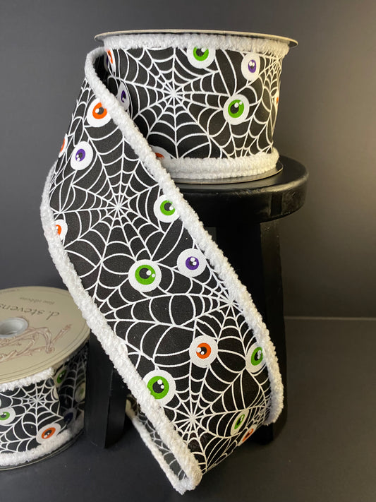 Halloween Ribbon with Spiderwebs and Eyeballs in a black with a fuzzy edge.  It's a 2.5"x10yds poplin ribbon.